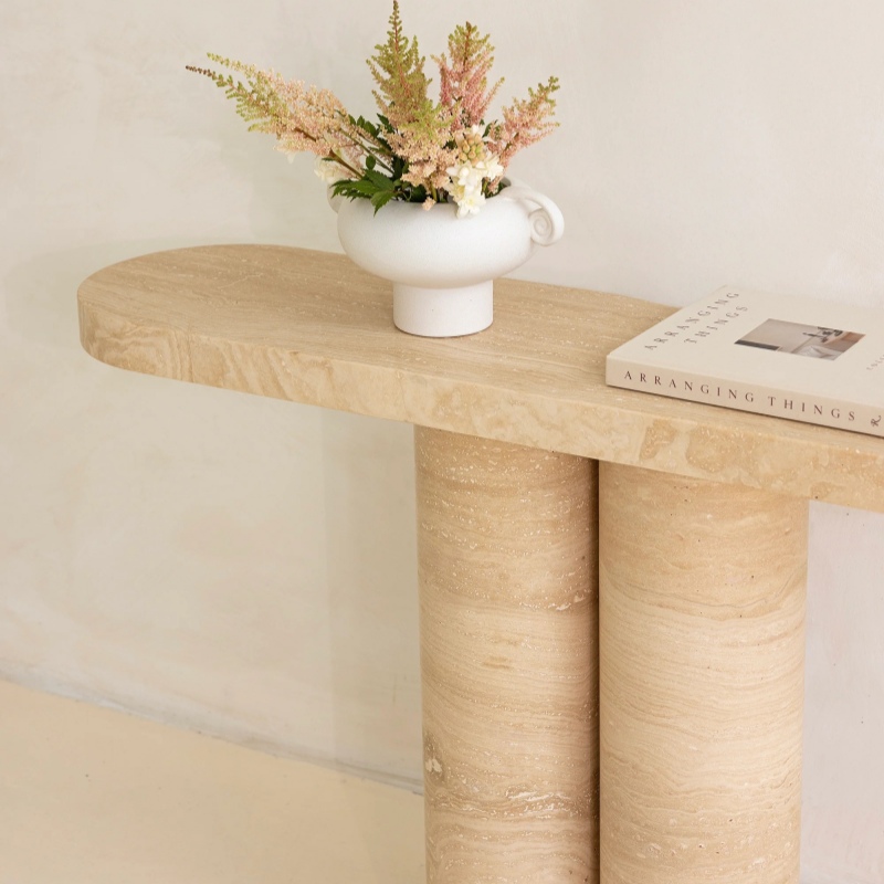 Beige travertine console table with vase and book - stylish accent piece for entryway