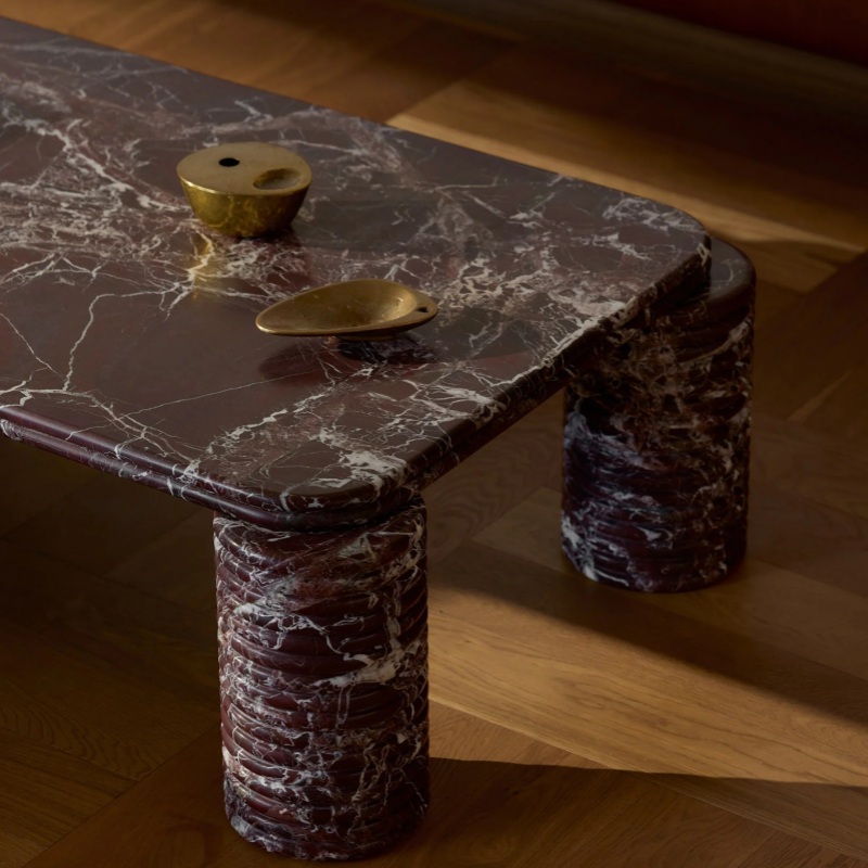 Close-up of Rosso Levanto Marble Coffee Table with brass decor - white veined stone texture detail