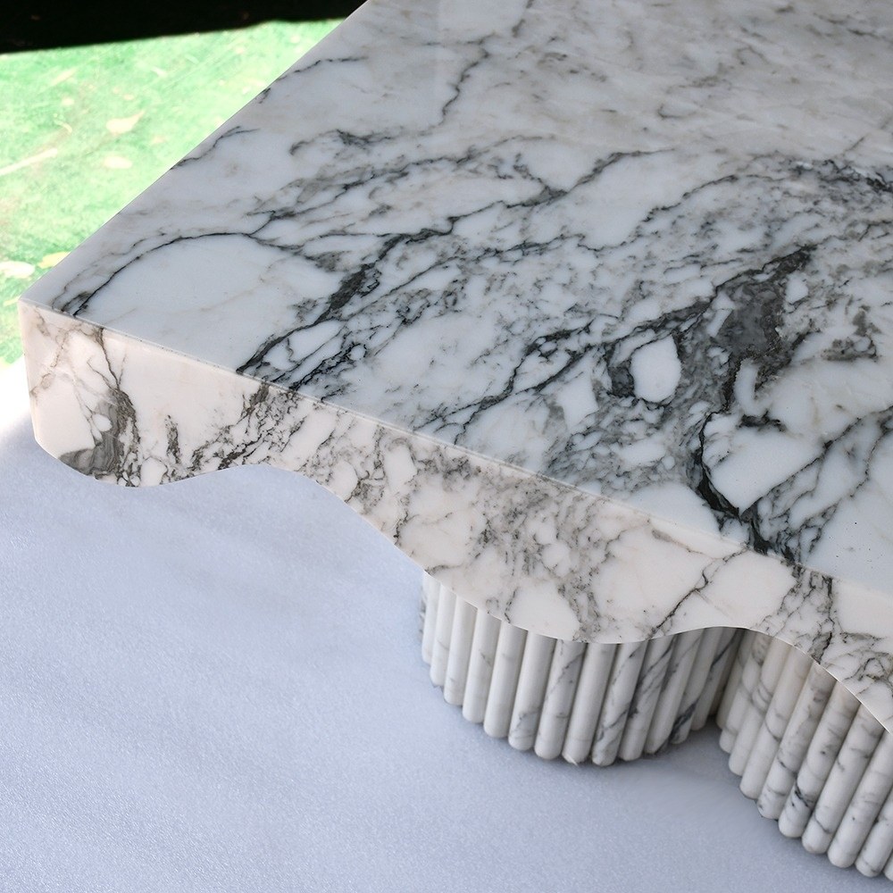 Sculptural Carrara marble coffee table with fluted column bases - modern organic design